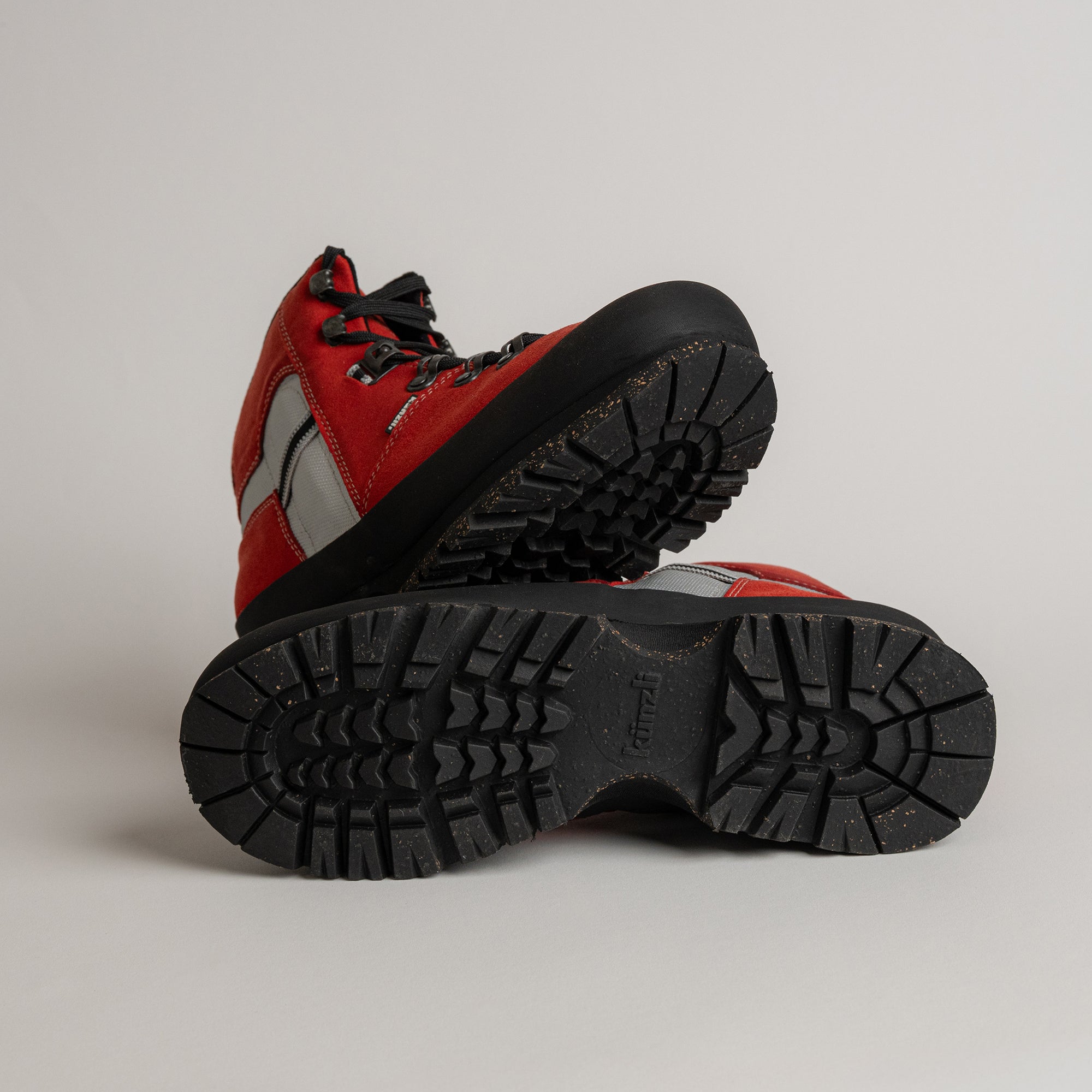 Rote Kuenzli Schuhe mit robusten Sohlen, ideal für Outdoor-Aktivitäten und Waldtraining.