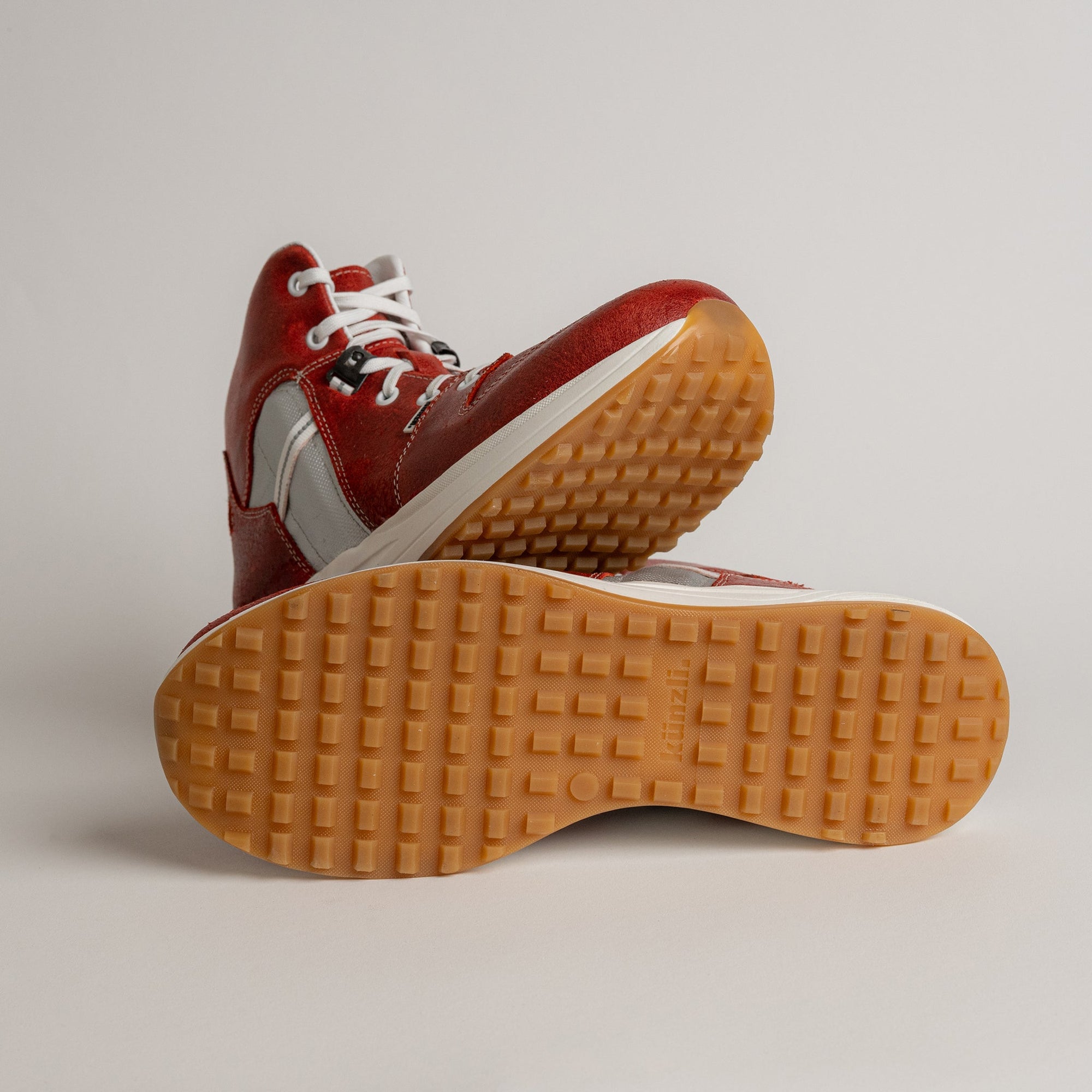 Rote Kuenzli Schuhe mit weißer Sohle und markantem Profil auf hellem Hintergrund.