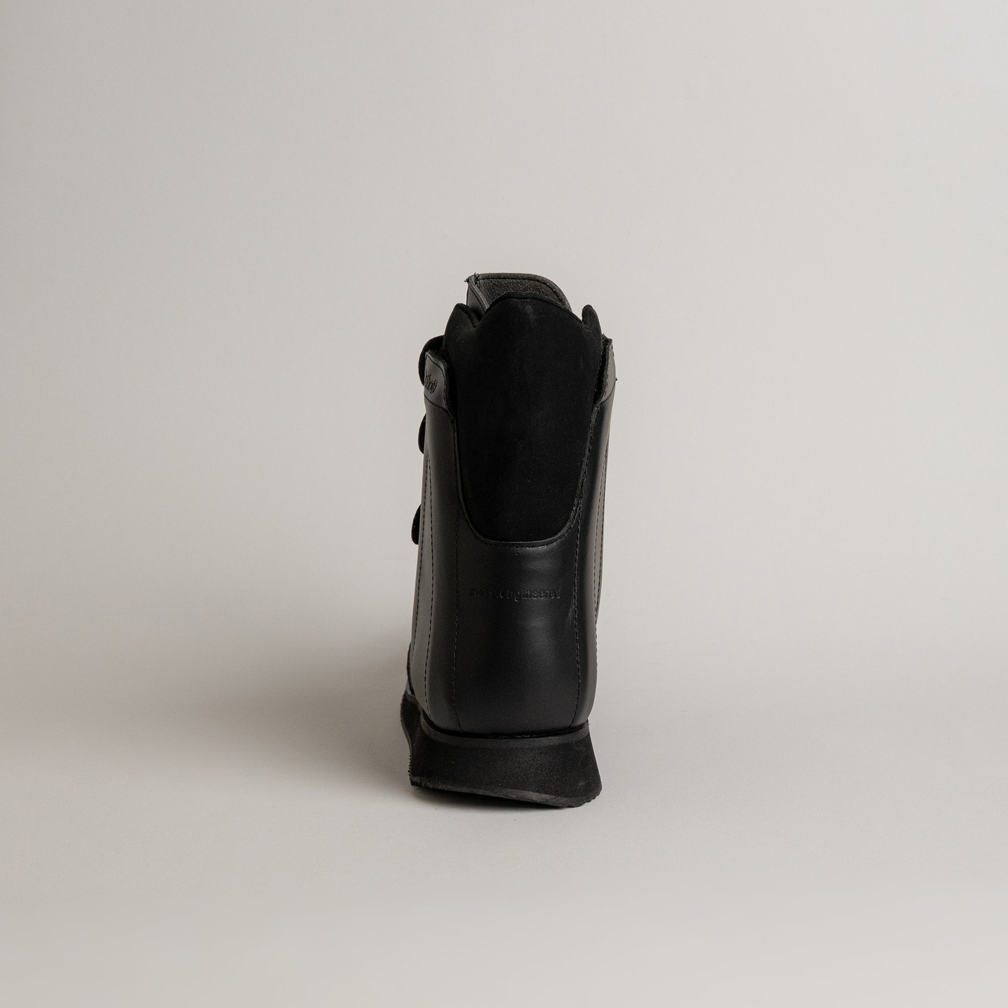 Schwarzer Lederschuh von Kuenzli Schuhe, Rückansicht auf neutralem Hintergrund.