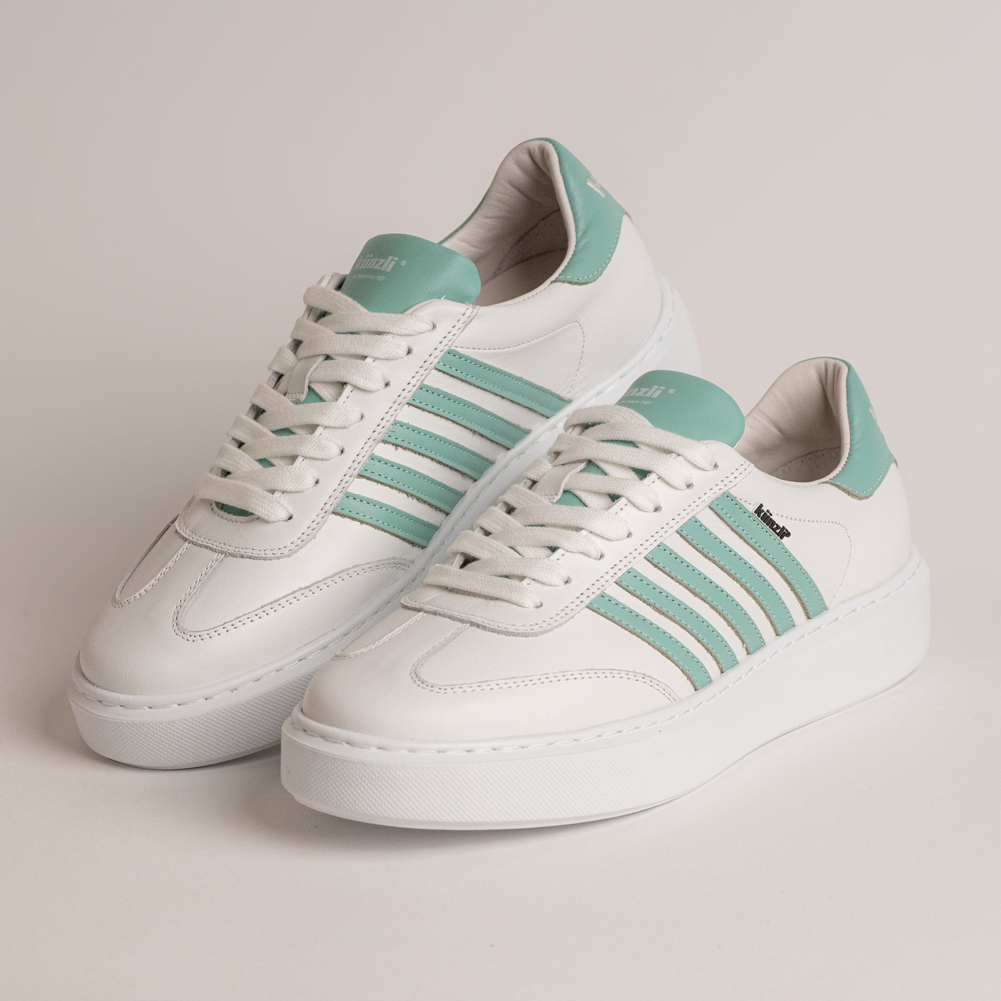 Weiße Kuenzli Schuhe mit grünen Streifen, ideal für stilvolle Freizeitaktivitäten.